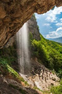Waterfall cascading down rocky cliff - Afurj Waterfall Khinalig hiking, Azerbaijan